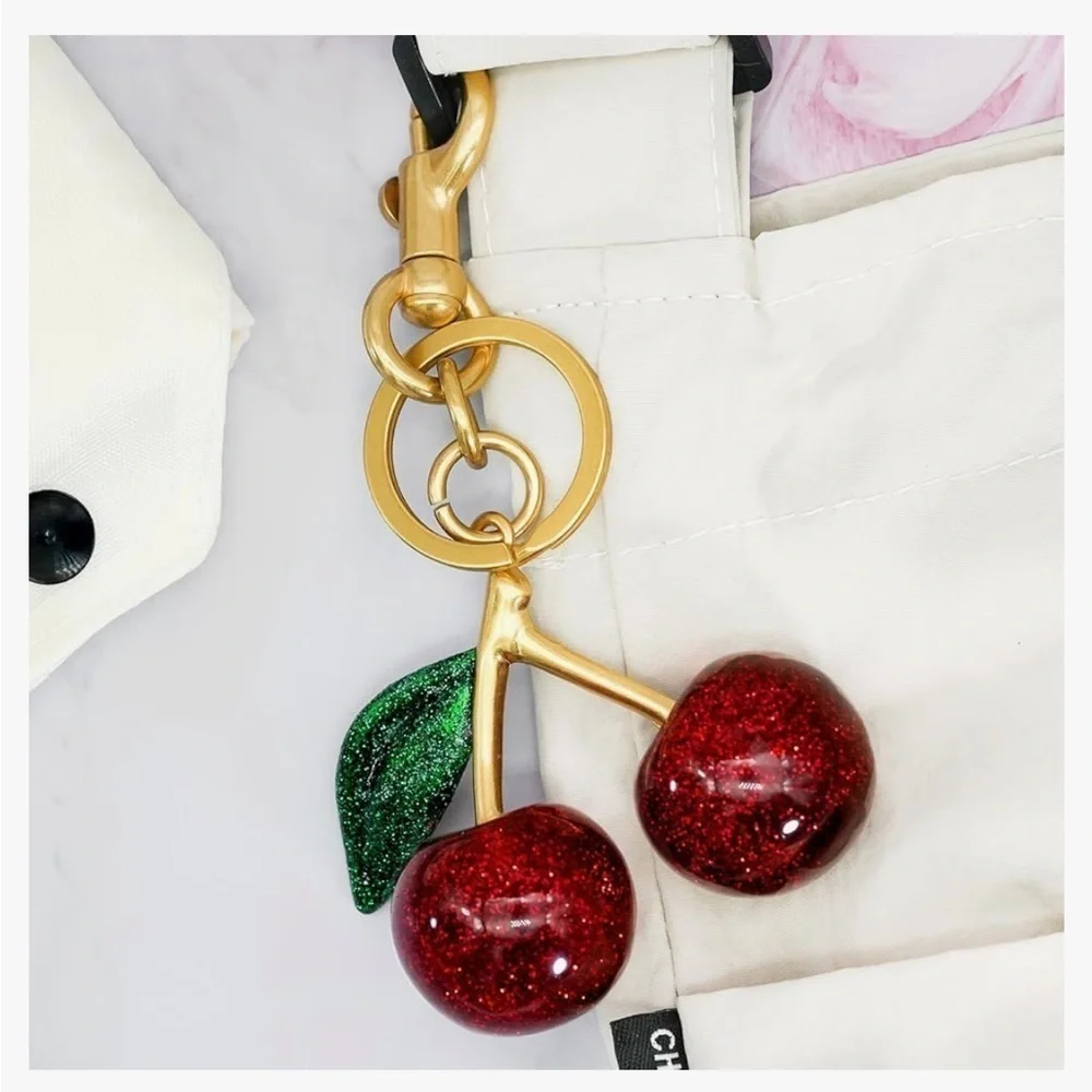 Cherry bag charm keychain with gold hardware clips onto your coach bag or ju…